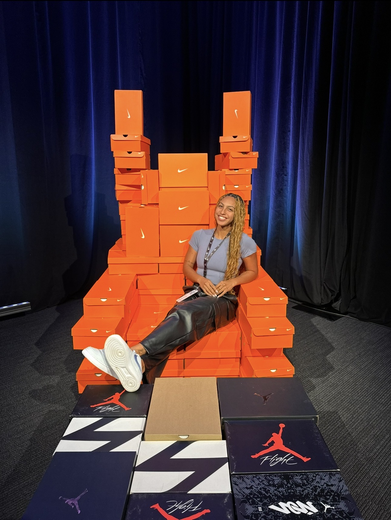 Jackson sitting and smiling on throne made of Nike and Jordan shoe boxes.